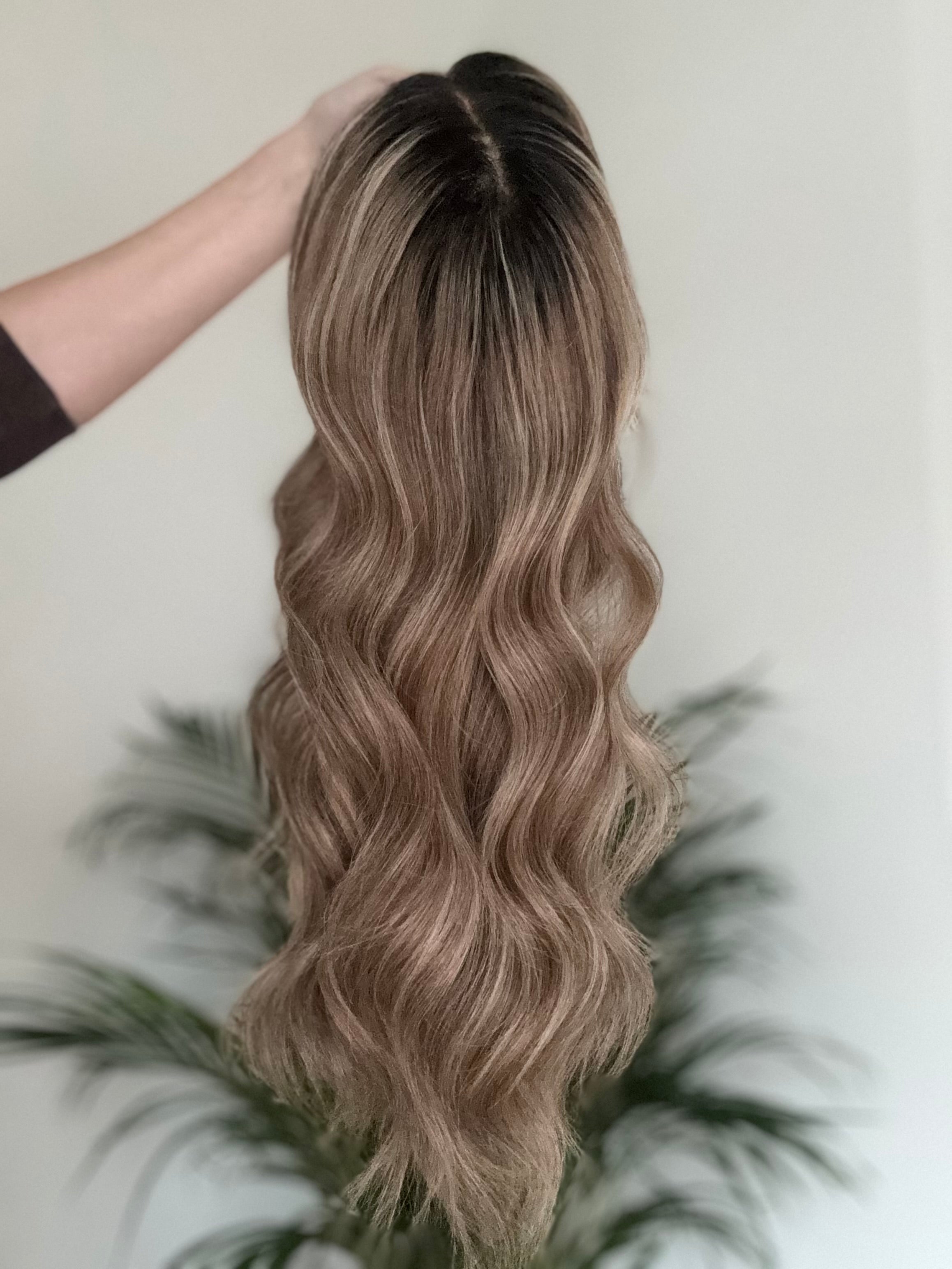 Close up of natural darker root on brown blonde balayage human hair wig