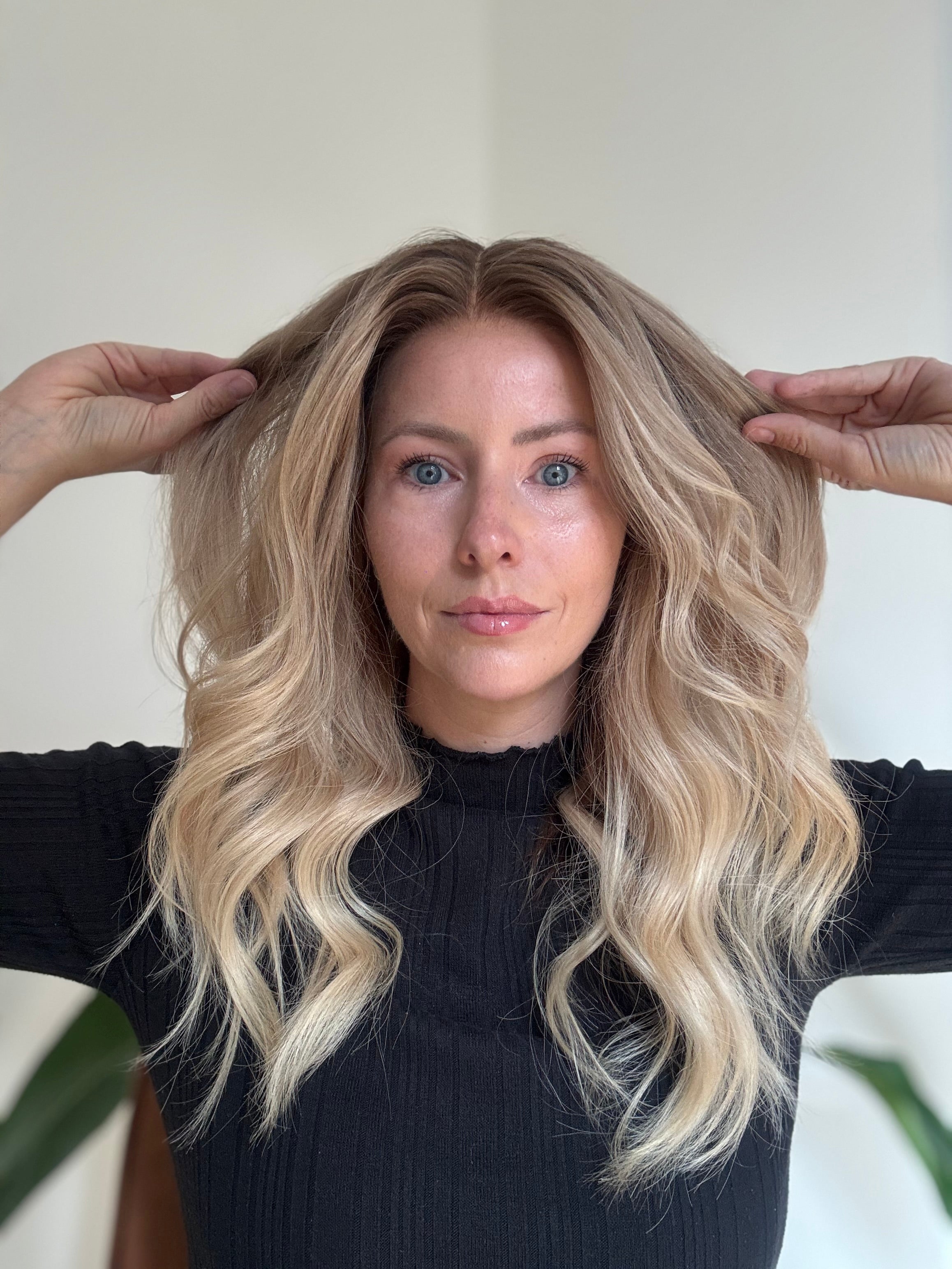 Natural looking blonde human hair wig with soft waves and darker roots